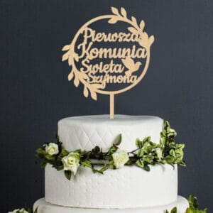 vertical shot of a white happy birthday dream cake with green leaves at the bottom